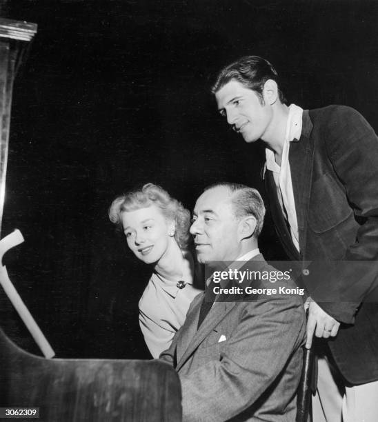 American songwriter Richard Rodgers with Iva Withers and Stephen Douglass, two of the cast members of the production of 'Carousel' which is showing...