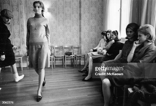 Debutantes selected to model in the debutante dress show at the Berkeley Hotel in London practice their moves.
