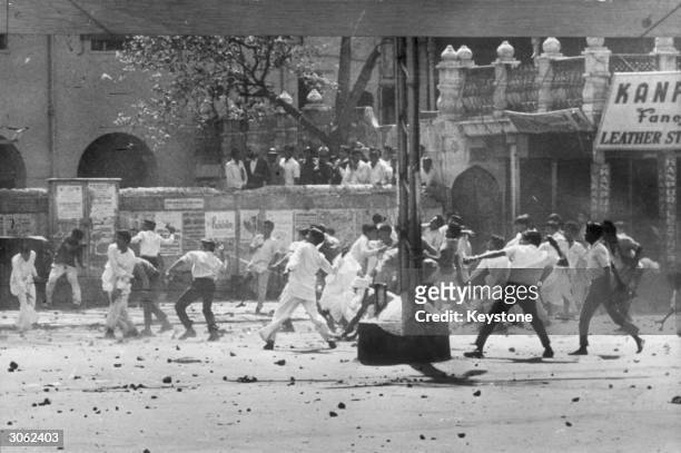 Stone throwing by a mob in Chandni Chowk shopping centre, Old Delhi during riots between Hindus and Sikhs over the future of Punjab State.
