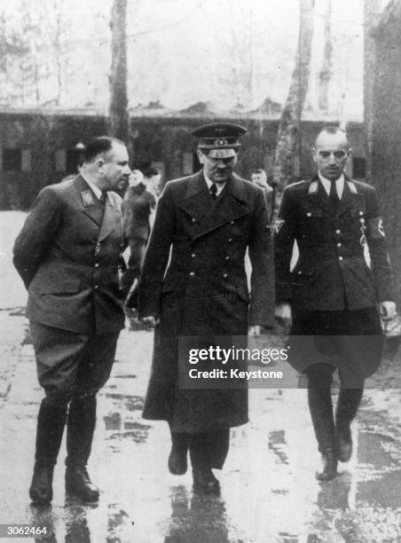 German Nazi Party leader Martin Bormann , one of Hitler's closest advisors talking with the Fuhrer outside his headquarters. On the right is Erwin...