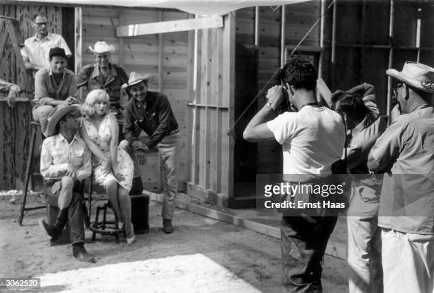 The cast and crew of John Huston's 'The Misfits' line up for a publicity shoot. The group includes writer Arthur Miller, actor Eli Wallach, director...