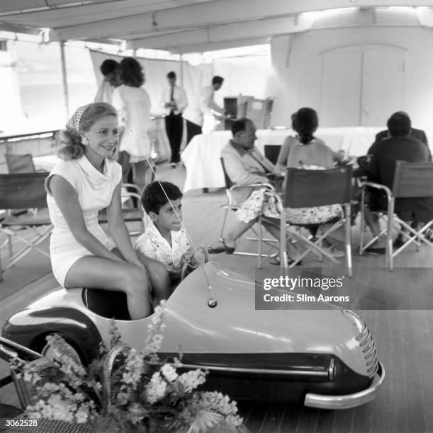 Athina Livanos, first wife of shipping magnate Aristotle Socrates Onassis, on board Aristotle's yacht 'Christina' with her son Alexander , in Monte...