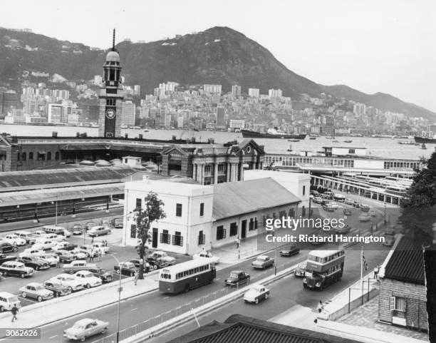Under the clock tower ,Kowloon railway terminus and across the harbour on Hong kong Island is Victoria.