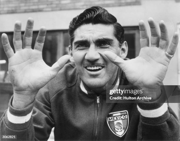 Antonio Carbajal, the Mexican goalkeeper, showing his injured left hand during a training session in Hertfordshire.