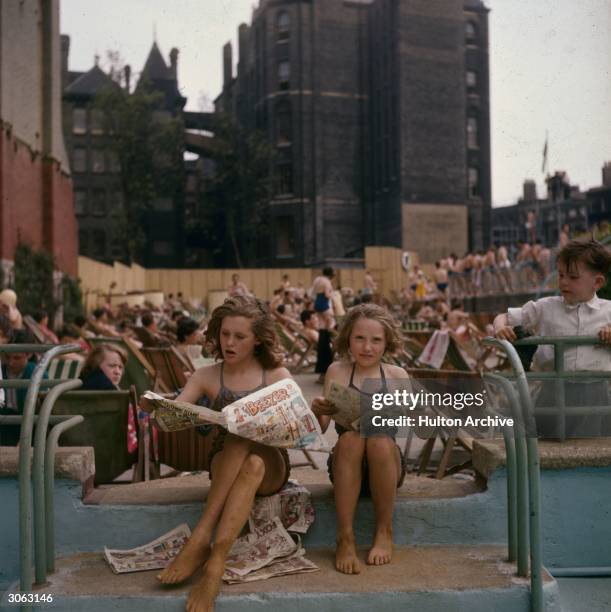 Sun worshippers and swimmers relax at the Oasis outdoor swimming pool in Holborn, London.