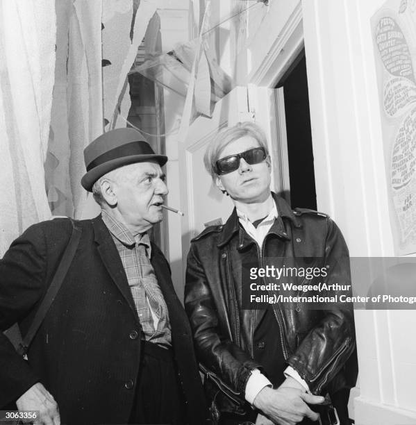 American photographer Arthur 'Weegee' Fellig with pop artist and film-maker Andy Warhol .