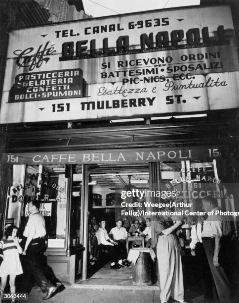 Friends gather to talk at the Caffe Bella Napoli on Mulberry Street, Little Italy, the Italian community of New York City.