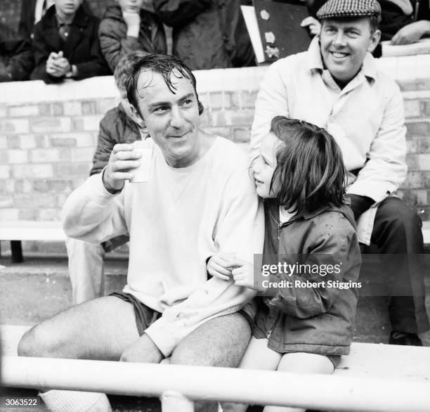 Tottenham Hotspur star player Jimmy Greaves takes a drink in the company of his daughter Mitzi.