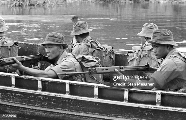 British soldiers on a boat in Borneo.