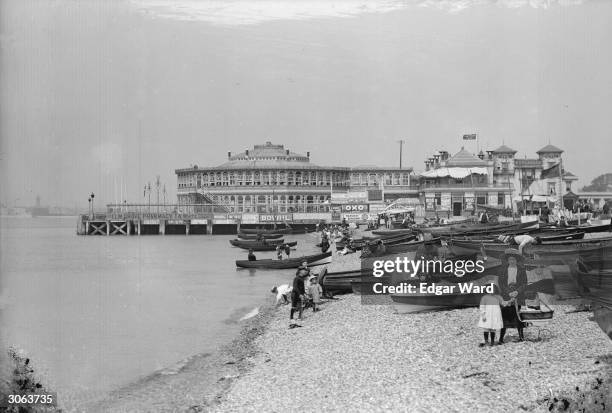Holidaymakers and boats on the beach at Southsea, Portsmouth.