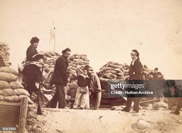 Battery at their artillery post during the civil war between the Third Republic and the Paris Commune, during the Franco-Prussian war. Marguerite...