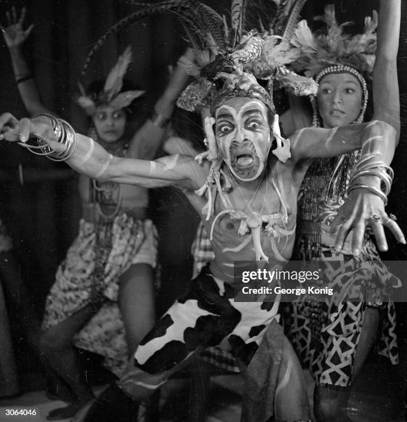 Jamaican ballet dancer Berto Pasuka plays a witchdoctor in a scene from 'They Came', a ballet which he also choreographed, at the Twentieth Century...