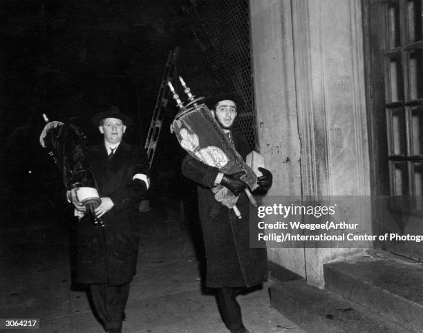 Two members of the synagogue rescuing the holy scrolls from the Congregation 'Israel Anschei Galicie Minhag Sfard' on East Houston Street, Manhattan,...