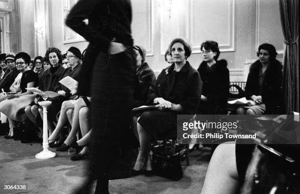 Potential customers at a Dior fashion show.