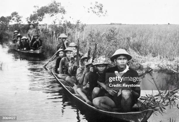 Viet Cong guerillas patrolling a water zone during the Vietnam War.