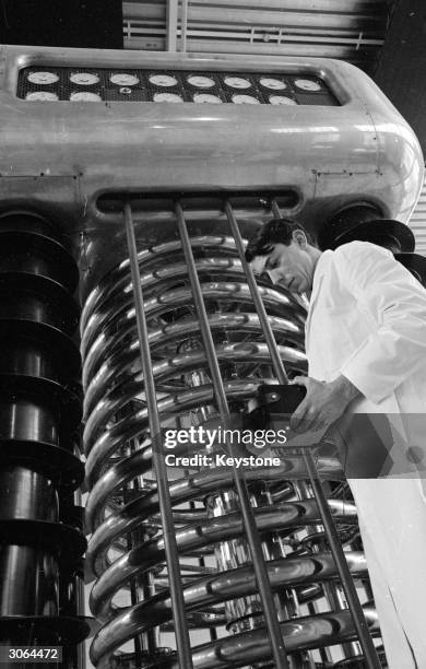 Scientist holding 600,000 volt accelerator.