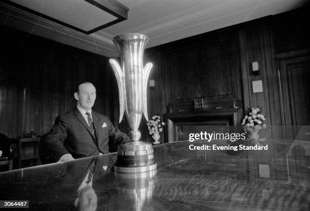 Bertie Mee , the manager of Arsenal football club, with the Fairs Cup which the team won after beating Anderlecht 3-0 at Highbury.