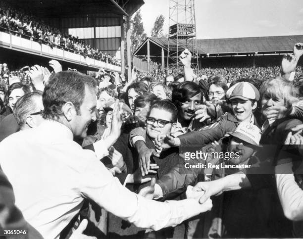 Fans greeting Queens Park Rangers manager Dave Sexton,after QPR had beaten Leeds 2-0 to go top of the league, however ten days later Liverpool beat...
