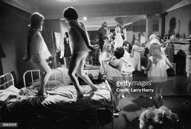 Pupils from St Trinian's all-girl school go wild at a pyjama party in their school dormitory.