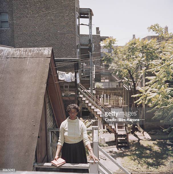 Poet Gwendolyn Brooks on the back steps of her home in Chicago.