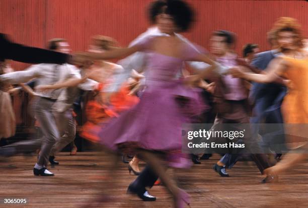 The dance floor turns into a blur of colour in a scene from 'West Side Story', directed by Robert Wise and Jerome Robbins.