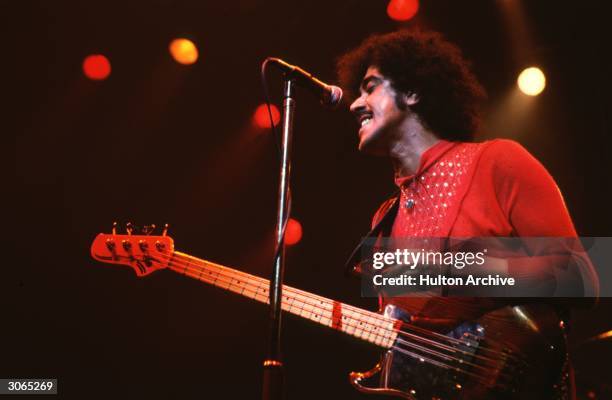 Phil Lynott , singer and bass guitarist with the Irish rock group Thin Lizzy, performs on stage.