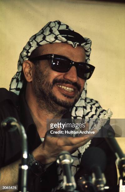 Palestinian leader Yasser Arafat, formerly Mohammed Abed Ar'ouf Arafat, who became leader of the Palestine Liberation Organisation in 1969 smiles...