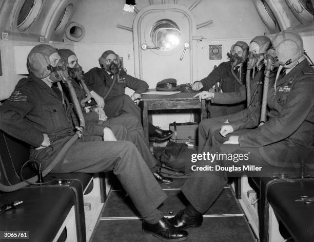 The pilots of Britain's first atomic bomb squadron experience the effects of high-altitude flying in a special decompression chamber at the RAF base...