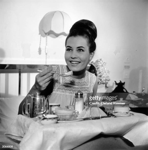 Dutch model Catharina Lodders, Miss Holland, having breakfast in bed the morning after winning the 1962 Miss World Beauty Pageant in London, UK.