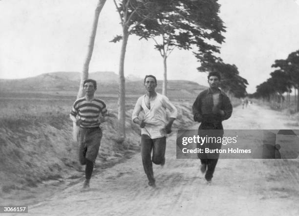 Three athletes in training for the marathon at the Olympic Games in Athens.
