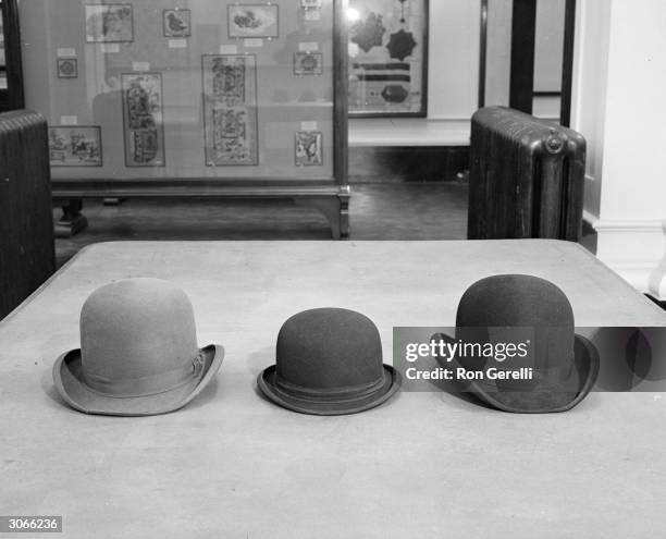 Three bowler hats on display at the Victoria and Albert Museum, London.