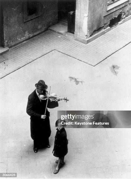 Violinist plays on the streets of Budapest. Many Hungarian musicians who were formerly in orchestras or gypsy bands must improvise a living as best...