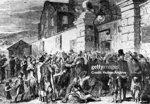 Starving peasants clamour at the gates of a workhouse during the Irish potato famine.