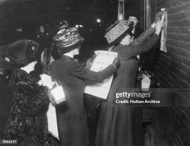 American suffragettes led by Miss Beatrice Brown posting bills advertising a lecture by the English suffragette Sylvia Pankhurst in New York.