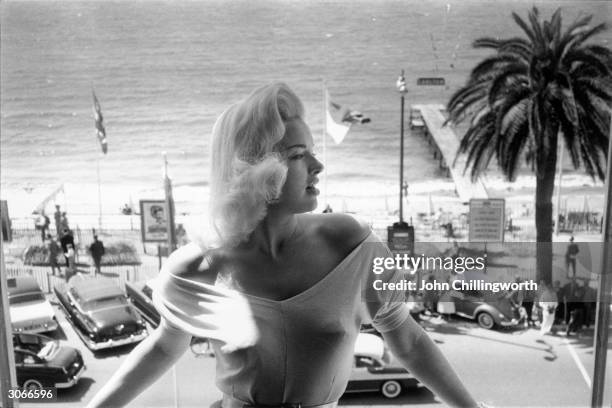 Blonde bombshell Diana Dors at Cannes' International Film Festival. Original Publication: Picture Post - 8396 - Diana - Queen Of Cannes - pub. 1956