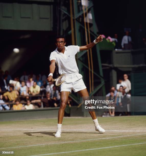 American tennis champion Arthur Robert Ashe Jnr , the first black player to win a major men's tennis tournament, on court at Wimbledon.