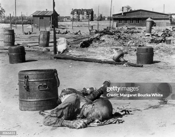 The corpse of a Polish prisoner at Erla concentration camp near Magdeburg in Germany, burnt by the Germans in the finals days before the camp was...