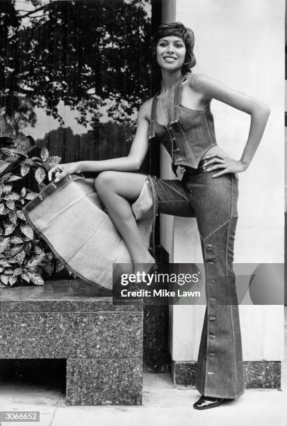 Model wears buttoned flared trousers with a matching waistcoat-styled top at a preview of the 'Miss Levi' spring collection, Sonesta Tower Hotel,...