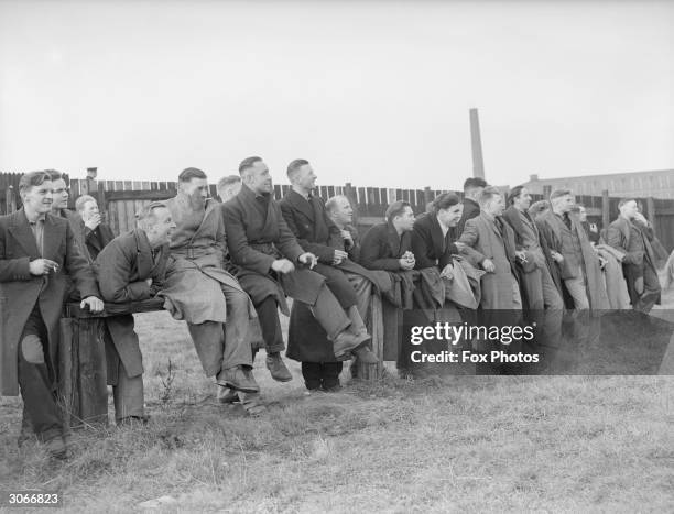 German prisoners-of-war watching a football match at a POW camp situated in a disused mill in the north of England.