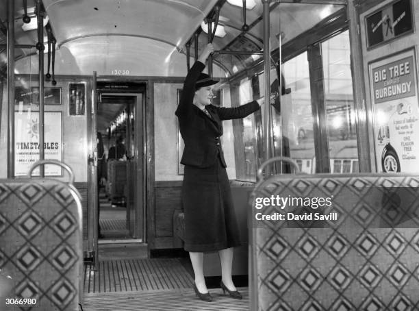 Woman in a 'new design' London Underground train.