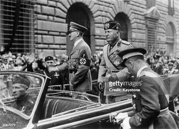 German dictator Adolf Hitler and Italian dictator Benito Mussolini drive through Rome.