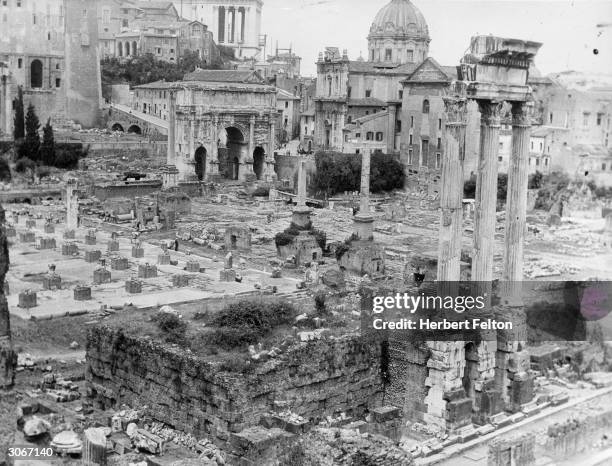 The Temples of Castor and Pollux in the foreground of the Forum in central Rome.