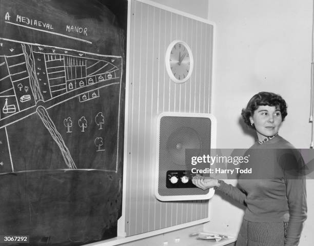 Schoolteacher Jean Breht switches on the loudspeaker in her classroom at London County Council's first comprehensive high school at Kidbrooke in...