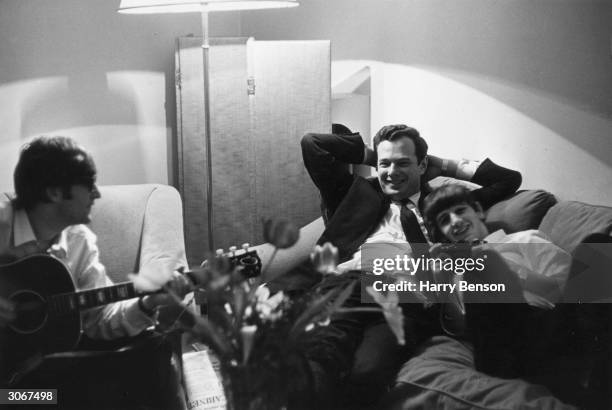 Band manager Brian Epstein relaxing in Paris with Beatles members John Lennon and Ringo Starr.