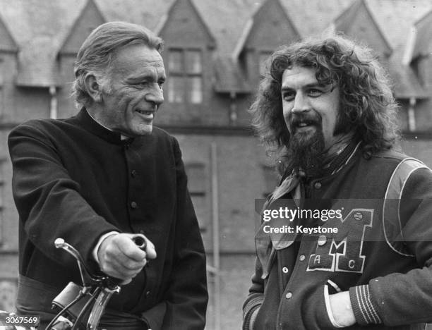 Welsh actor Richard Burton with Scottish comedian and actor Billy Connolly on the set of the film 'Absolution'.