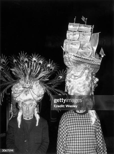 Comedians Hugh Lloyd and on the right Terry Scott stars of TV series 'Hugh and I' modelling wigs for their parts as the ugly sisters in the pantomime...