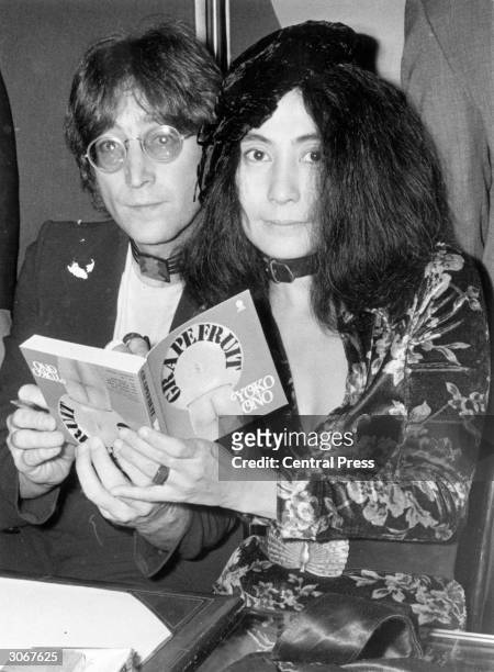 John Lennon with his wife, Yoko Ono at a book signing session in Selfridges department store in London.