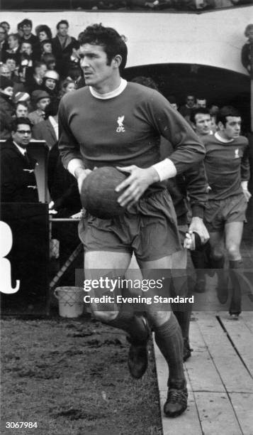 Liverpool FC footballer 'big' Ron Yeats enters the pitch carrying the ball. He was manager of Tranmere Rovers from 1972 until 1975.