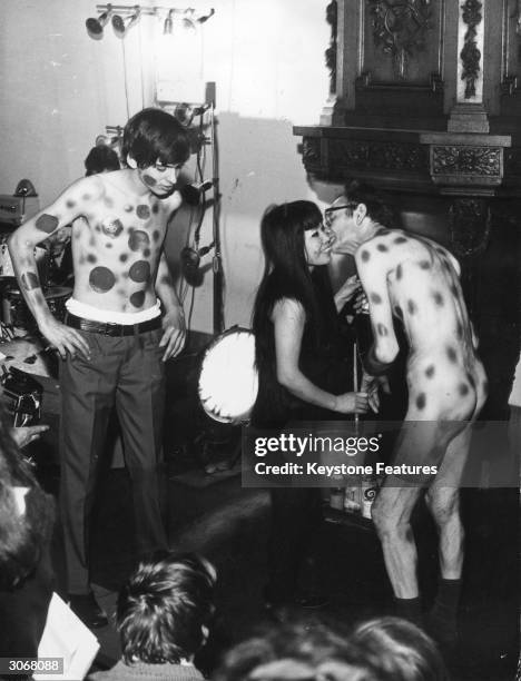 Painter Yayoi Kusama with two of her 'works of art'. She paints naked bodies in an attempt to make them more beautiful . At an exhibition in Utrecht...