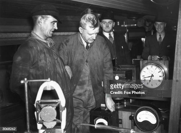 Fireman T H Bray on the left and next to him Driver R J Duddington who made history by driving the LNER locomotive 'Mallard' at 125mph. They are in...